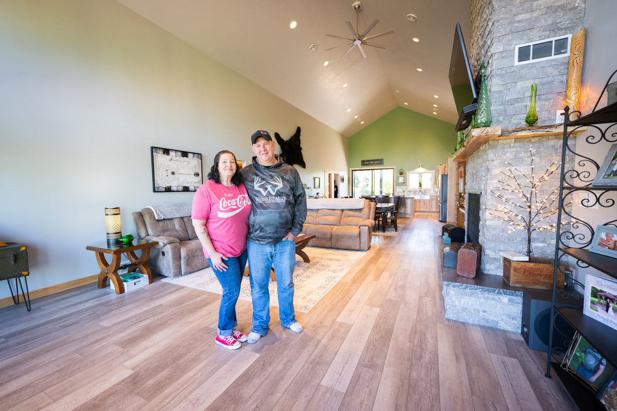 Couple standing in the living room of a barndominium