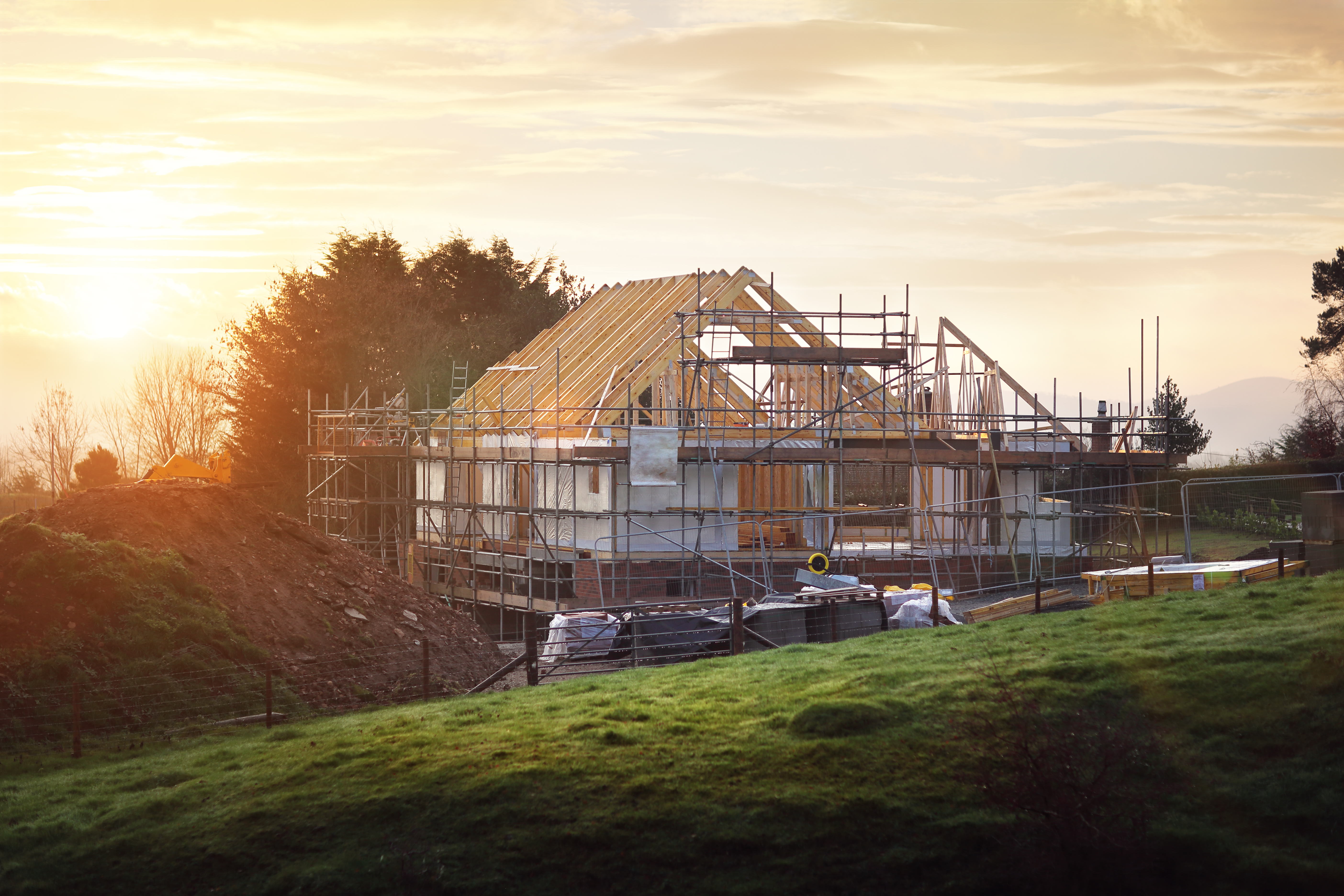 Framed house with scaffolding and home wrap