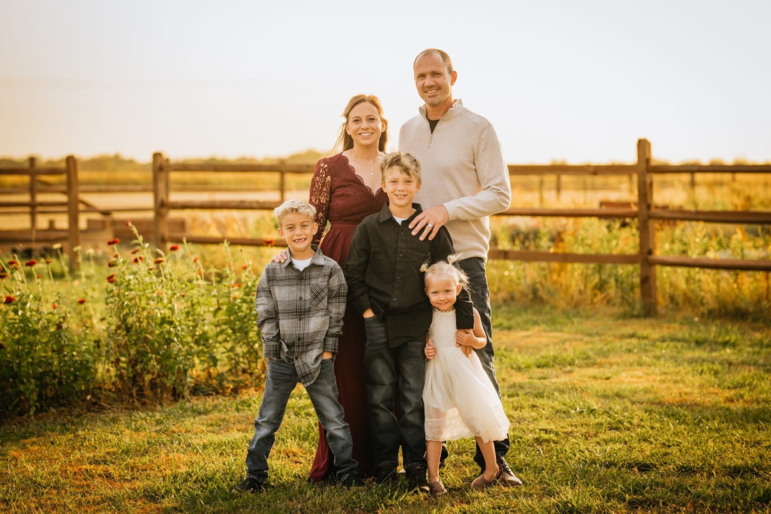 The Fritz family standing in a field on their flower farm.