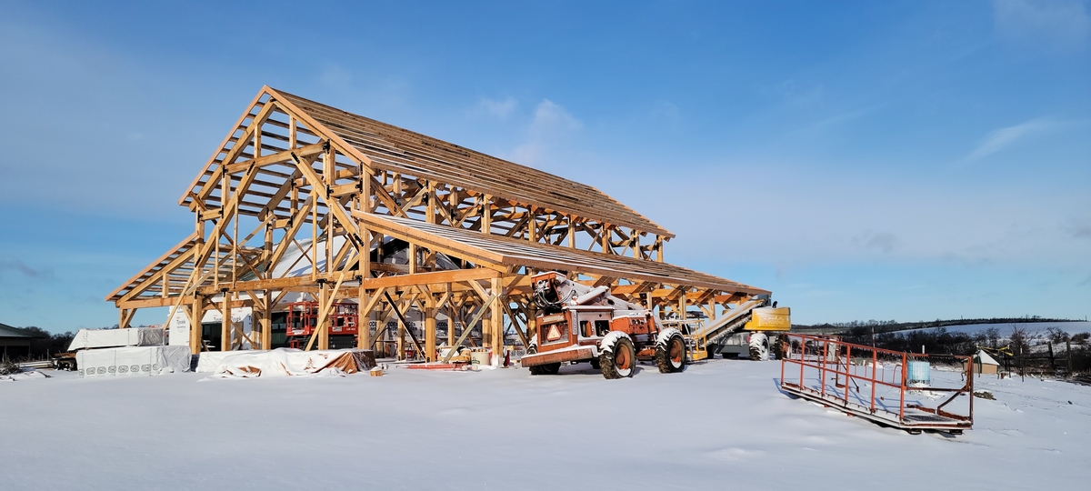 Barndominium frame surrounded by snow 