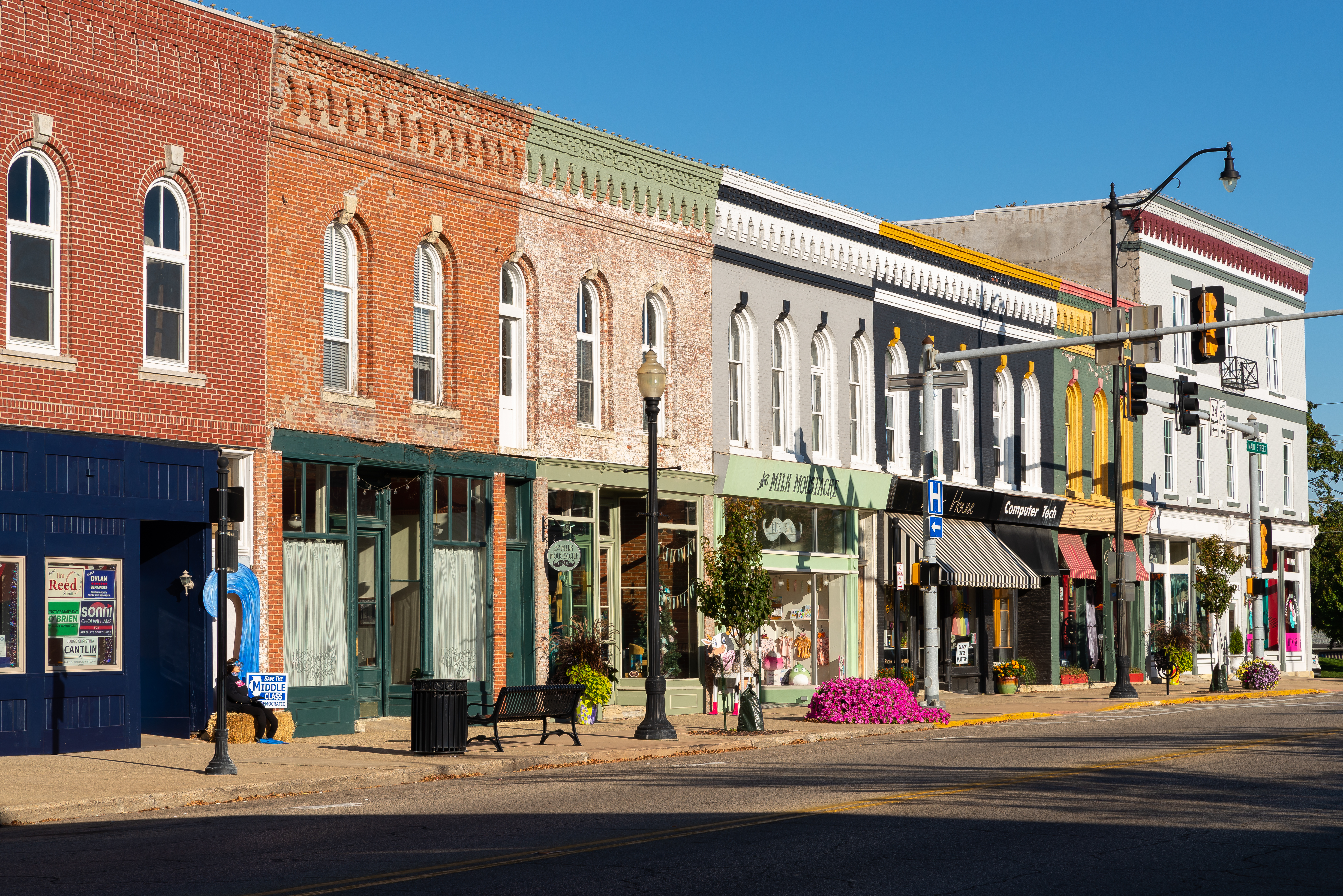 Colorful historic storefronts line downtown Princeton, Illinois on a sunny fall day.