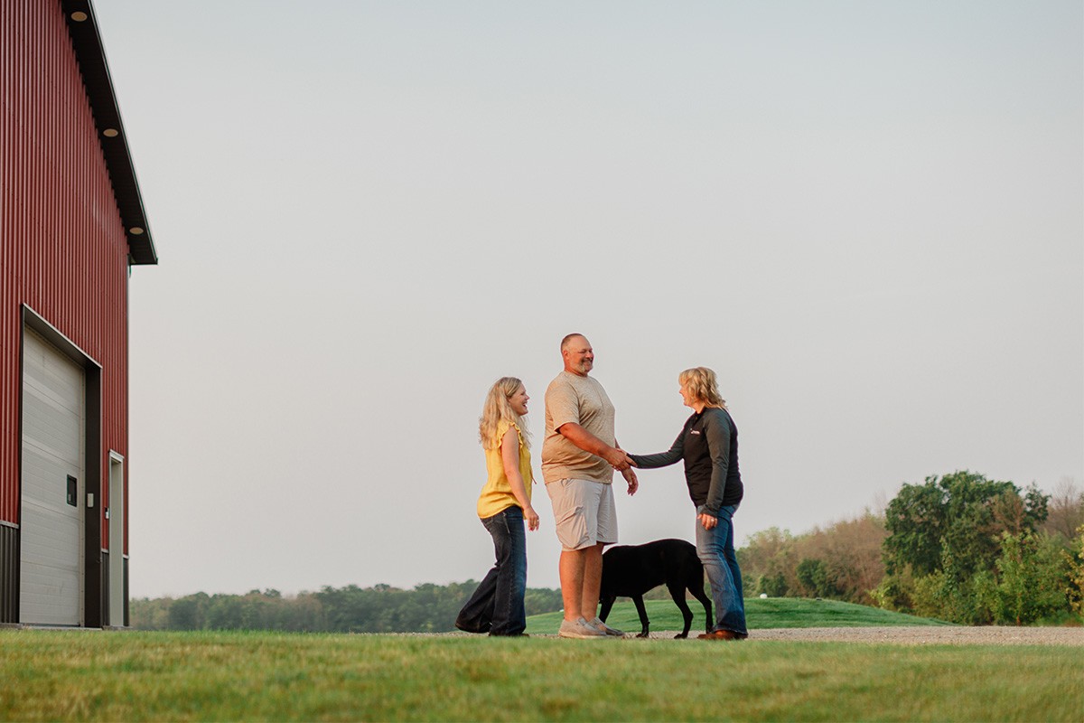 Man and woman shaking hands in a driveway