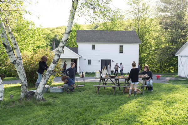 A rural outdoor summer party with a picnic table.