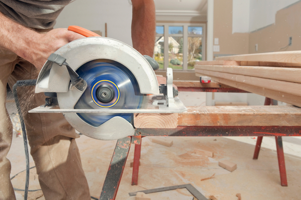 Circular saw cutting a piece of wood on a saw horse