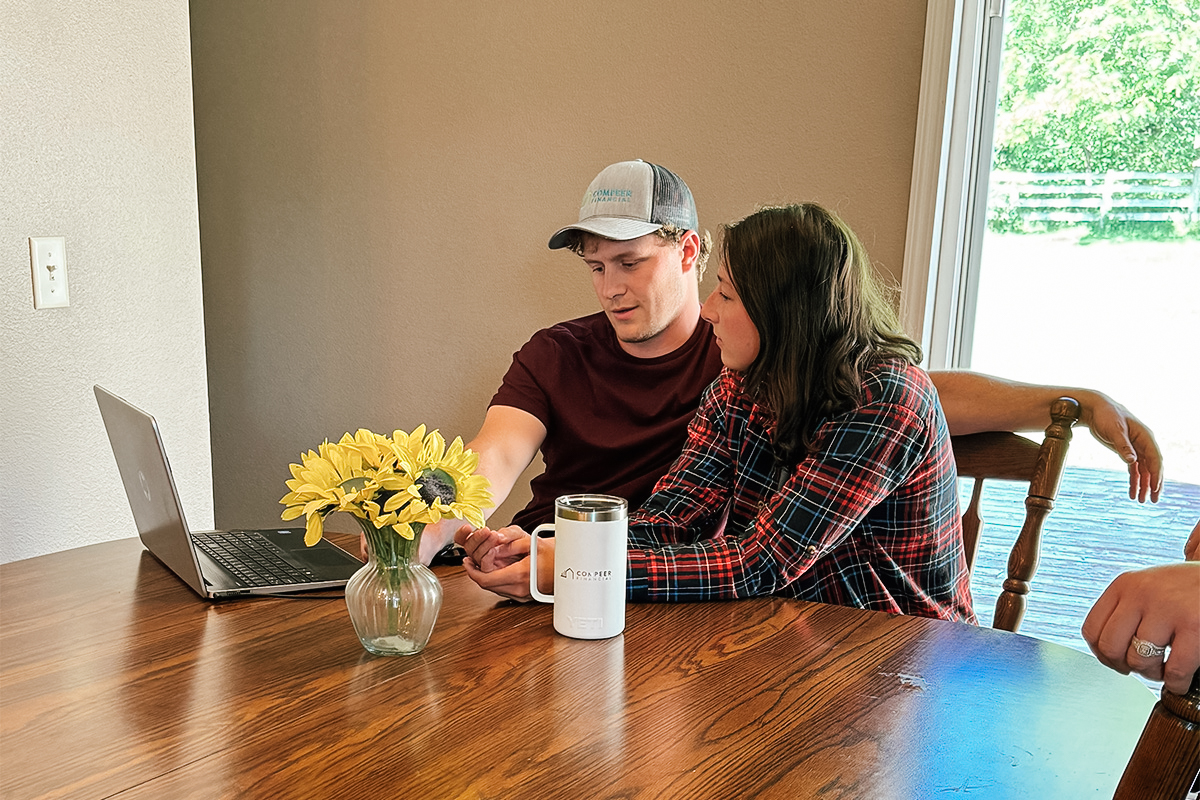 First-time homebuyers sit at a table taking an online homebuyer education course.