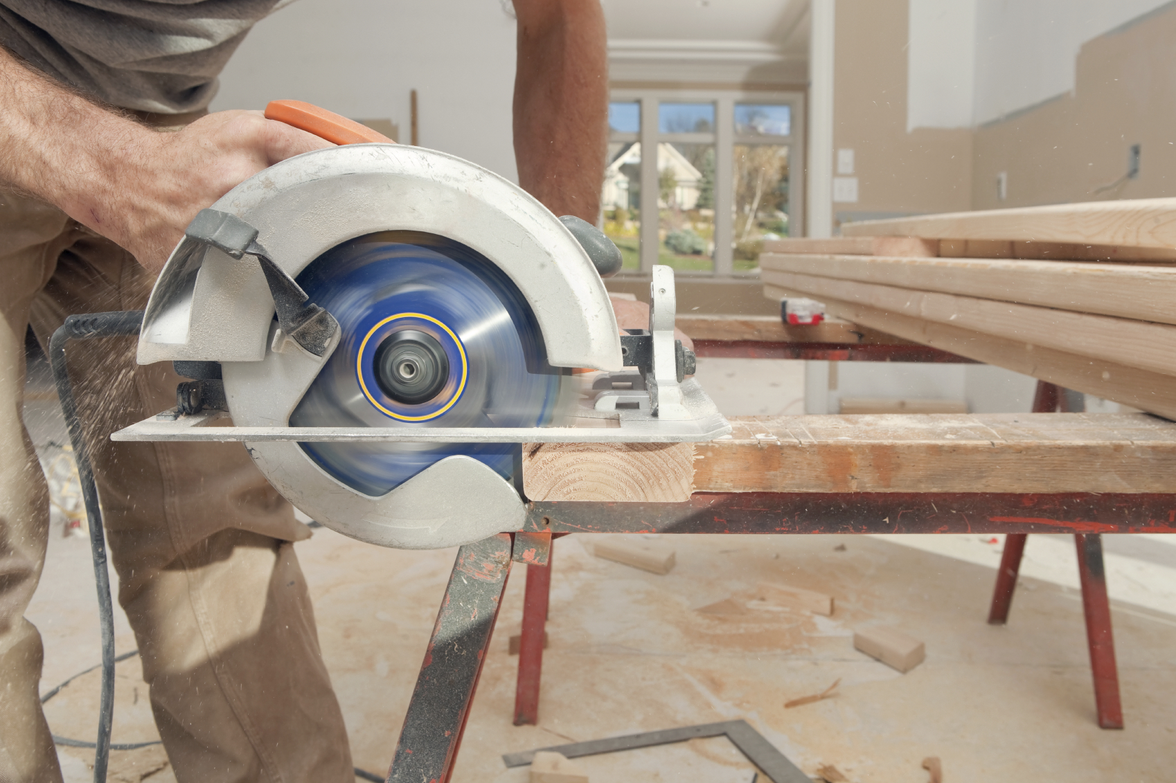 Circular saw cutting a piece of wood on a saw horse